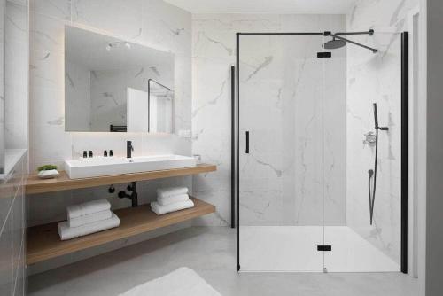 a white bathroom with a sink and a shower at Villa Georgiana in Funtana
