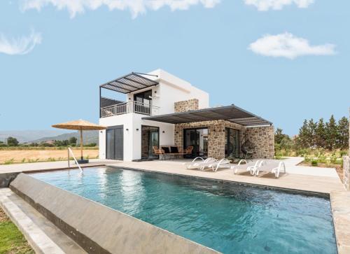 a villa with a swimming pool and a house at Kalloni Sunset Villas Lesvos in Skala Kallonis