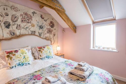 a bedroom with a bed with towels on it at Ocean View, Lowestoft in Lowestoft