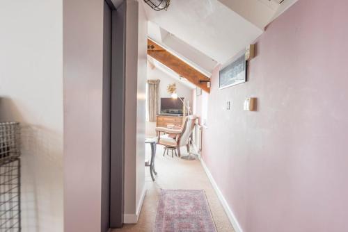 a hallway with a table and a desk in a room at Ocean View, Lowestoft in Lowestoft