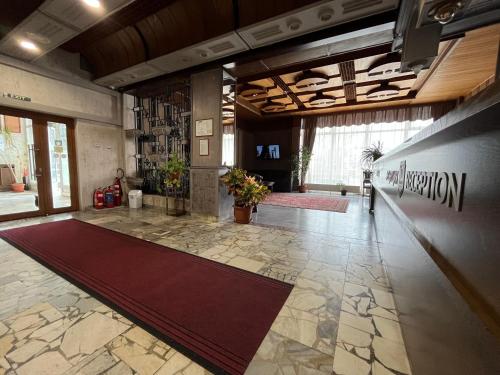 a lobby with a large red rug on the floor at Park Hotel Ivailo in Veliko Tŭrnovo