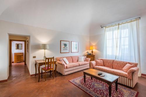 a living room with two couches and a table at Tenuta Mocajo in Guardistallo