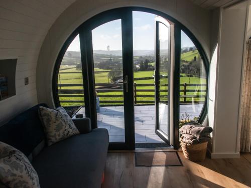 a living room with a large glass door with a view at Ceunant in Aberystwyth