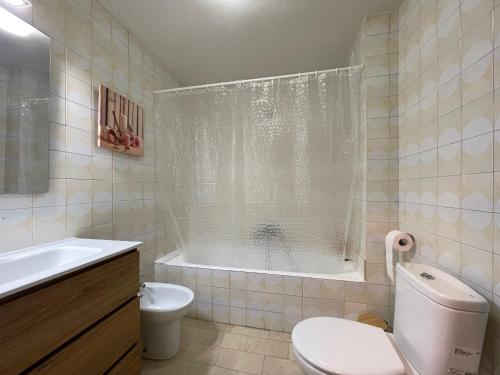 a bathroom with a tub and a toilet and a sink at Terracita de Gayarre in Tudela