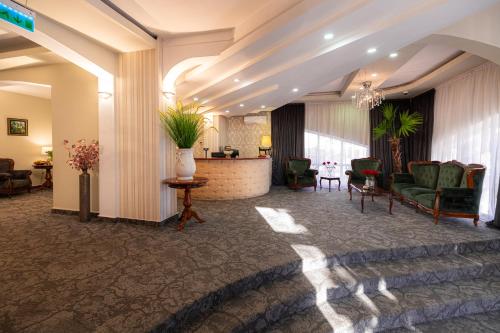a lobby of a hotel with chairs and a table at Hotel Brilliant Meseș in Zalău