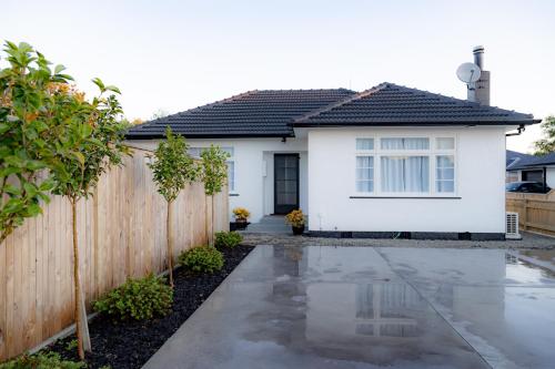 a white house with a wooden fence at House in Palmerston North, New Zealand in Palmerston North