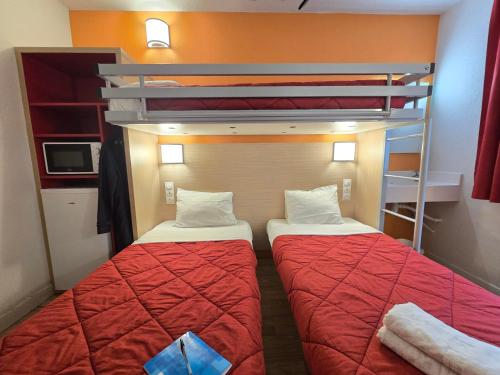 a small room with two beds and a bunk bed at Premiere Classe Evry Sud - Mennecy in Ormoy