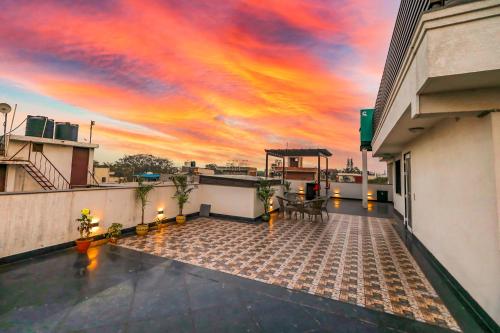 a sunset on the roof of a building at FabHotel La Paz Stay B&B in New Delhi