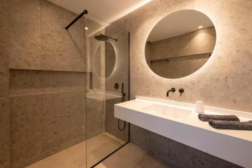 a bathroom with a shower and a sink and a mirror at Aethra Villas Luxury Retreat in Anissaras
