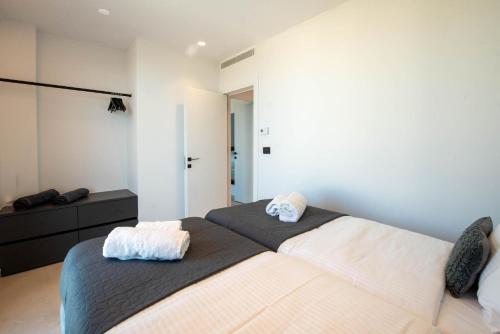 a bedroom with two beds with towels on them at Aethra Villas Luxury Retreat in Anissaras