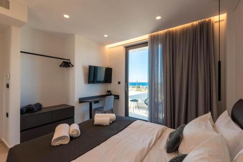 a bedroom with a bed with a view of the ocean at Aethra Villas Luxury Retreat in Anissaras