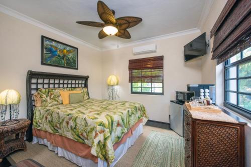 a bedroom with a bed and a ceiling fan at The Pilot House in Rock Sound