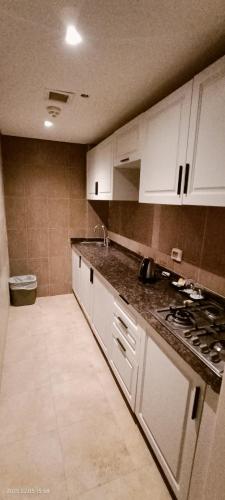 a kitchen with white cabinets and a counter top at Beau Site Belle Vue Hotel in Marsa Matruh