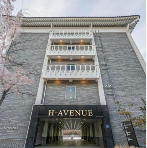 a building with a sign that says he avenue at H Avenue Gyeongju Bulkuk temple in Gyeongju