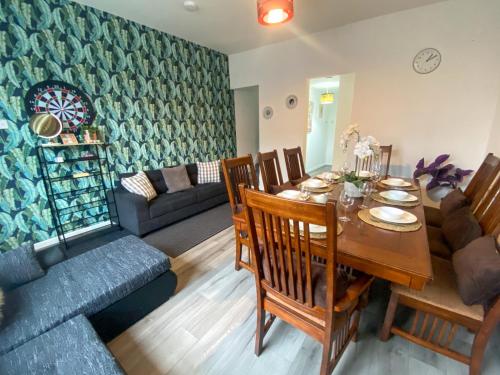 a living room with a table and a couch at 5 bedroom Luxury Townhouse near City Centre, sleep 16 in Manchester