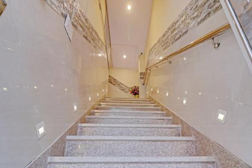 a staircase in a building with a vase of flowers at New Green Plaza in New Delhi