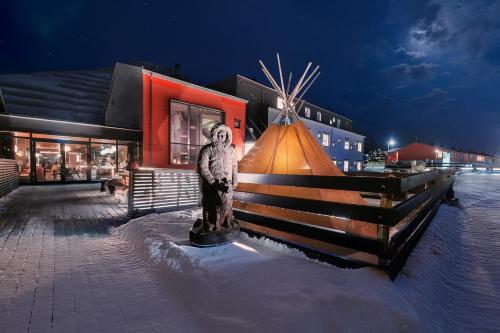 a statue of a man standing in front of a building at Svalbard Hotell | Polfareren in Longyearbyen