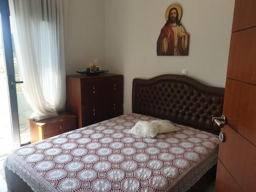 a bedroom with a bed with a pillow on it at Coastal maisonette in Nea Potidaea