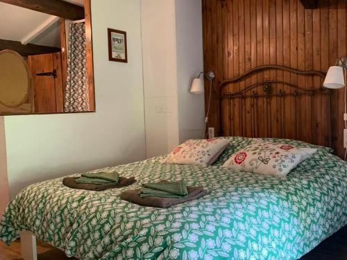 a bedroom with a bed with two towels on it at Les Trois Noyers in Tailhac