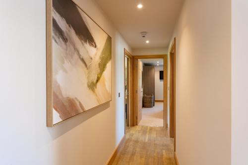 a hallway with a painting on the wall at Les Ormes Resort in St Brelade