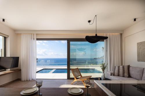 a living room with a view of the ocean at Rokkea Villa in Plakias