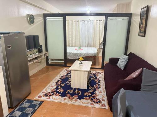 a living room with a couch and a table at AJs One Oasis 1 bedroom in Cagayan de Oro