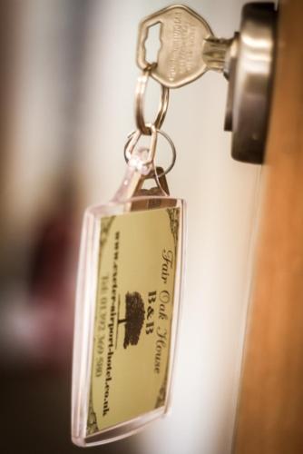 a key chain with a tag on a door at Fair Oak House Exeter Airport in Exeter