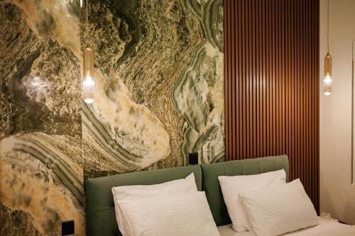 a room with a green couch with pillows and a wall at SeaGreen Luxury Apartment in Alexandroupoli