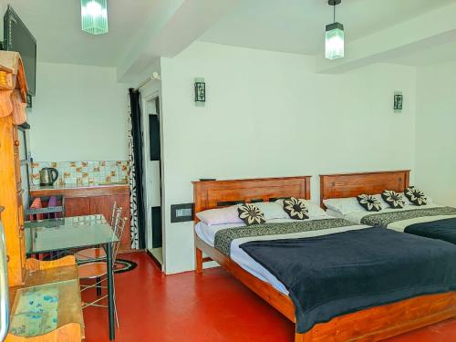 a bedroom with two beds and a table at White House in Haputale