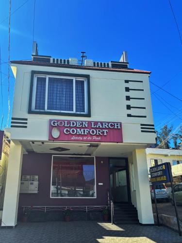 a building with a sign that reads golden lunchcourt company at Golden Larch Comfort in Ooty