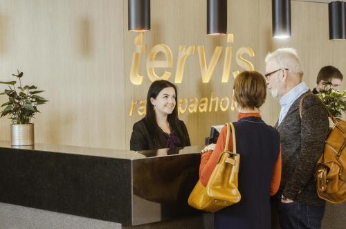 a group of people standing around a reception desk at Spa Tervis in Pärnu