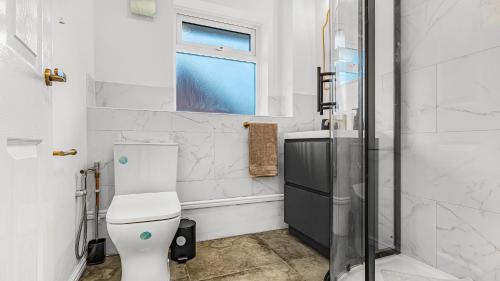 a bathroom with a toilet and a shower at Double Bedroom Spacious Home near NEC JLR HS2 BHX Airport with Free Parking and wifi in Solihull