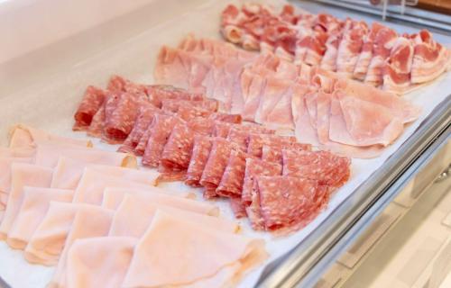 a display case filled with different types of meat at Best Western Plus Borgolecco Hotel in Arcore