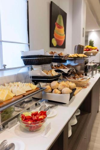 a buffet line with many different types of food at Best Western Plus Borgolecco Hotel in Arcore
