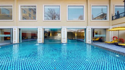 a large swimming pool in the middle of a building at Radisson Collection Hotel & Spa, Riverfront Srinagar in Srinagar