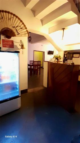 a living room with a flat screen tv and a kitchen at The Lovina Place in Mount Lavinia