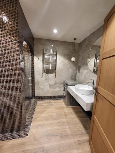 a bathroom with a sink and a toilet and a shower at Sea Breeze The Grand 250 in Nardaran