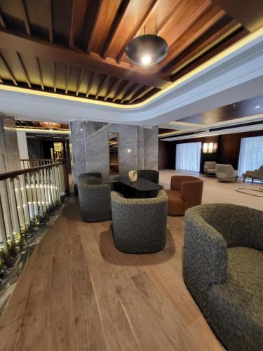 a lobby with couches and a table and chairs at Sea Breeze The Grand 250 in Nardaran