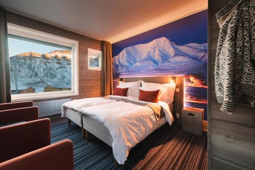 a bedroom with a large bed and a large window at Svalbard Hotell | Polfareren in Longyearbyen