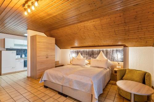 a bedroom with a bed and a table and a chair at Azalea in Olsberg