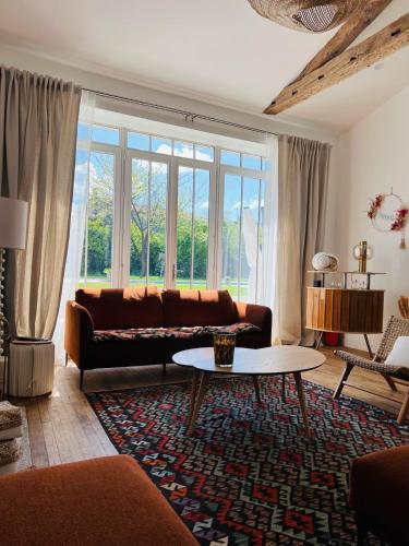 a living room with a couch and a table at La Rochelle Exceptional Property, Park, Pool, in La Rochelle