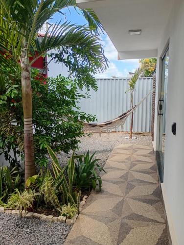 a walkway leading to the front door of a house at AYRE GOSTOSO POUSADA in São Miguel do Gostoso
