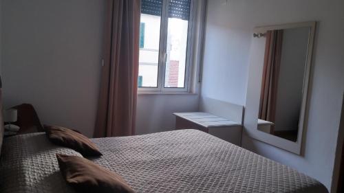 Ένα ή περισσότερα κρεβάτια σε δωμάτιο στο Hotel Ariston