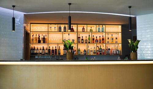 a bar with a lot of bottles of alcohol at Swissôtel Al Murooj Dubai in Dubai