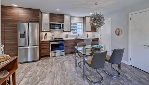 a kitchen with a glass table and stainless steel appliances at Spacious Conveniently Located 1BR in Myers Park in Charlotte