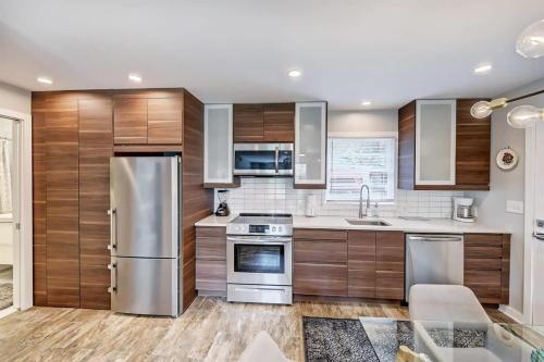 a kitchen with wooden cabinets and stainless steel appliances at Experience Myers Park in Style in Charlotte