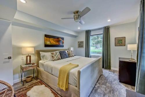 a bedroom with a large bed and a window at Spacious condo with easy access to Uptown in Charlotte