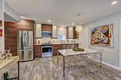 a kitchen with a table and chairs and a refrigerator at Spacious condo with easy access to Uptown in Charlotte
