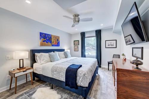 a bedroom with a large bed and a television at Chic and Relaxing 1BR in the Heart of Myers Park in Charlotte