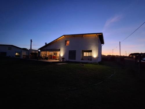 a house with lights on the side of it at night at LA CLARITA Chapadmalal in Chapadmalal